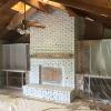 White washed brick and painted built-in cases create a beautiful contrast against the open beam wood ceiling.